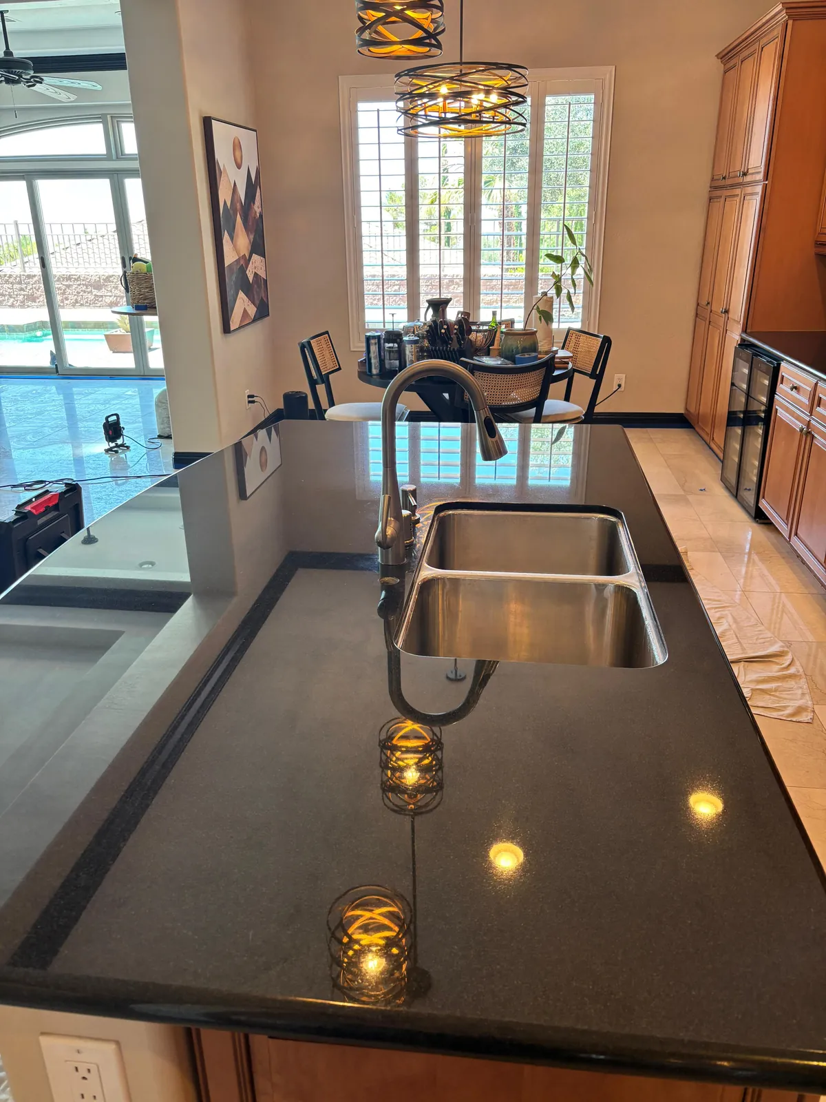 Clean polished black granite countertop around a sink after Henderson stone cleaning