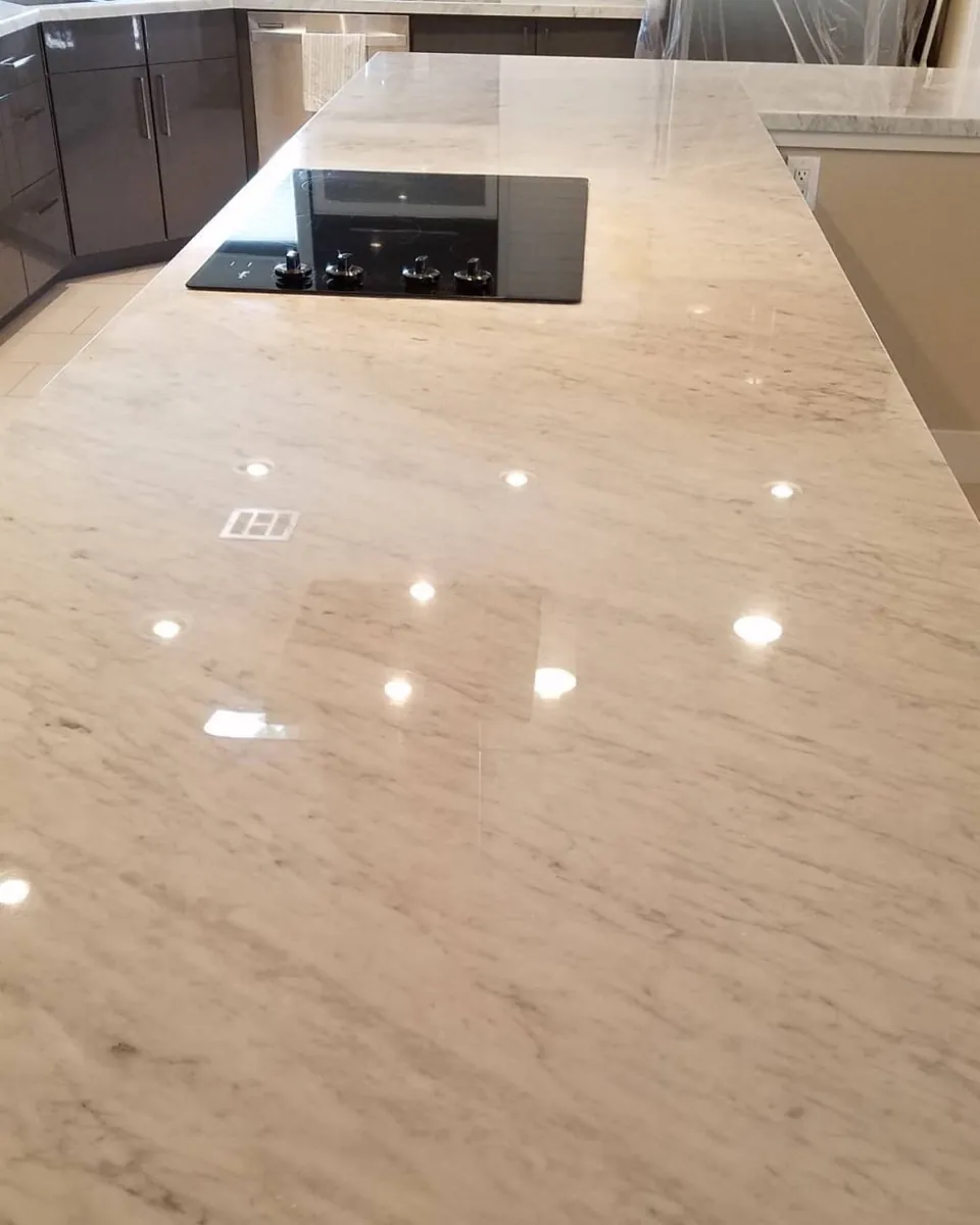 Polished Carrara marble island countertop with a mirror finish