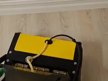 Orbital floor machine cleaning a light vinyl plank floor