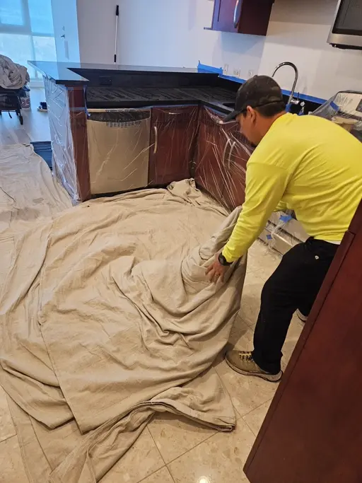 Countertop restoration setup with cabinets, floors, and nearby surfaces protected