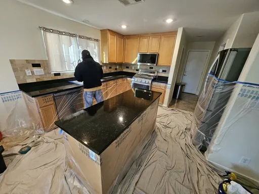 Dark granite kitchen counter during polishing