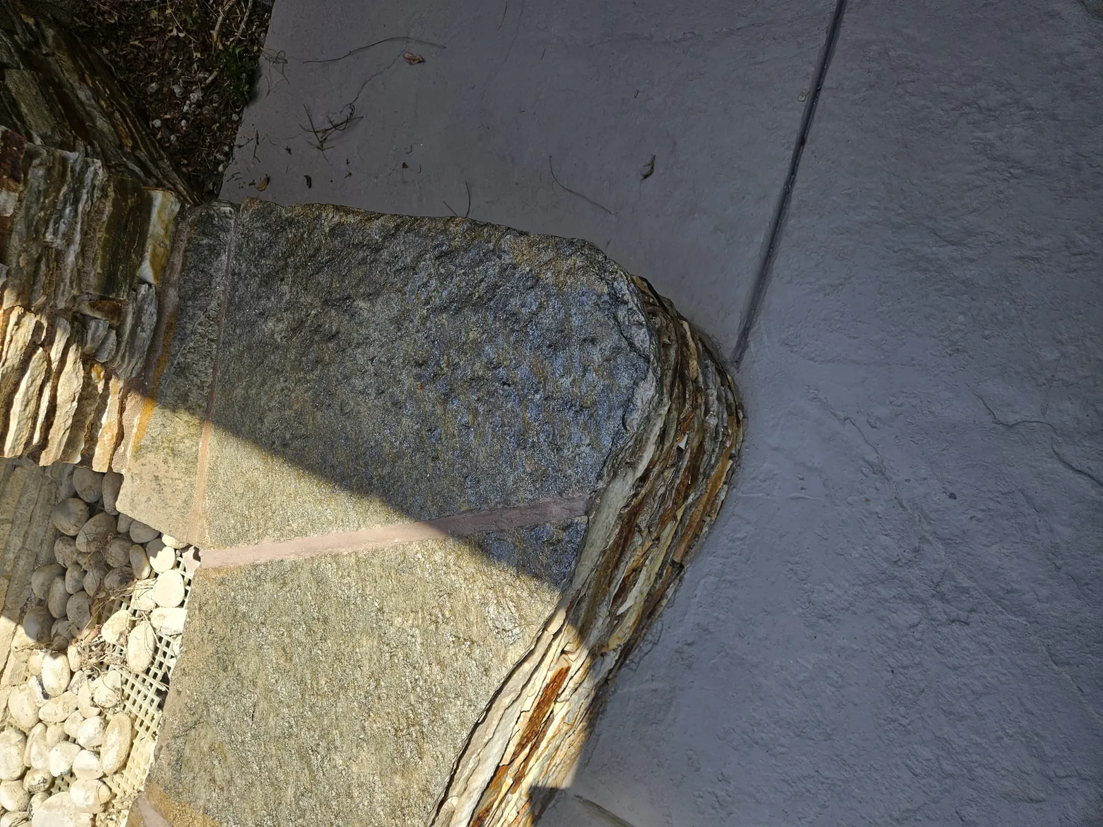 Closeup of repaired mortar joints on flagstone fountain caps
