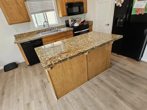 Cracked granite sink edge before repair and the finished kitchen countertop after (after)