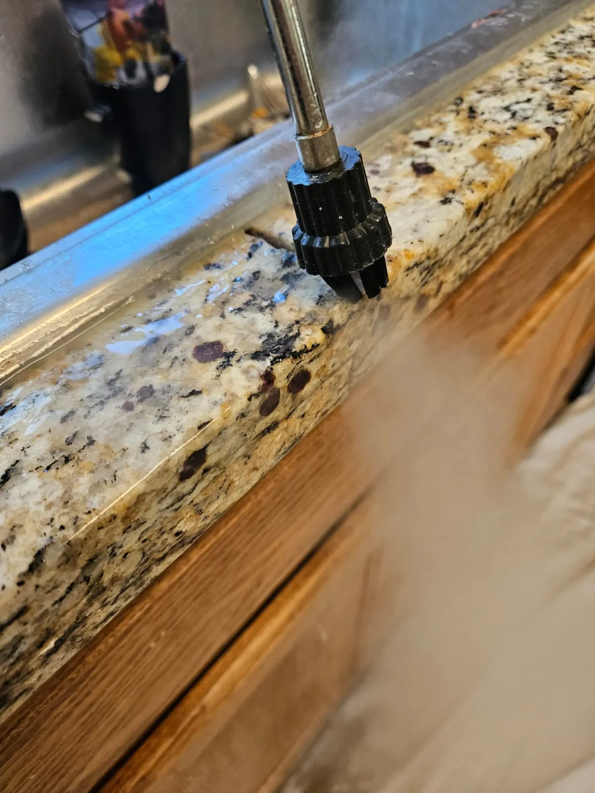 Rotary tool grinding granite edge