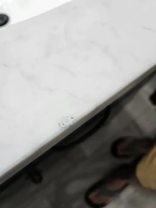Close-up of a marble countertop edge chip repair