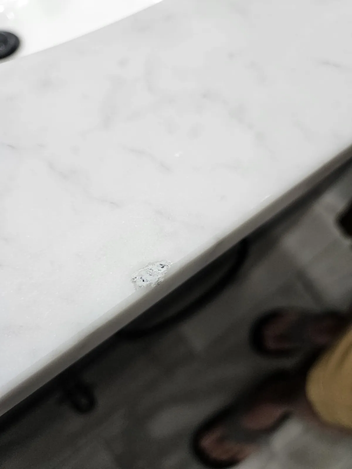 Close-up of a marble countertop edge chip repair