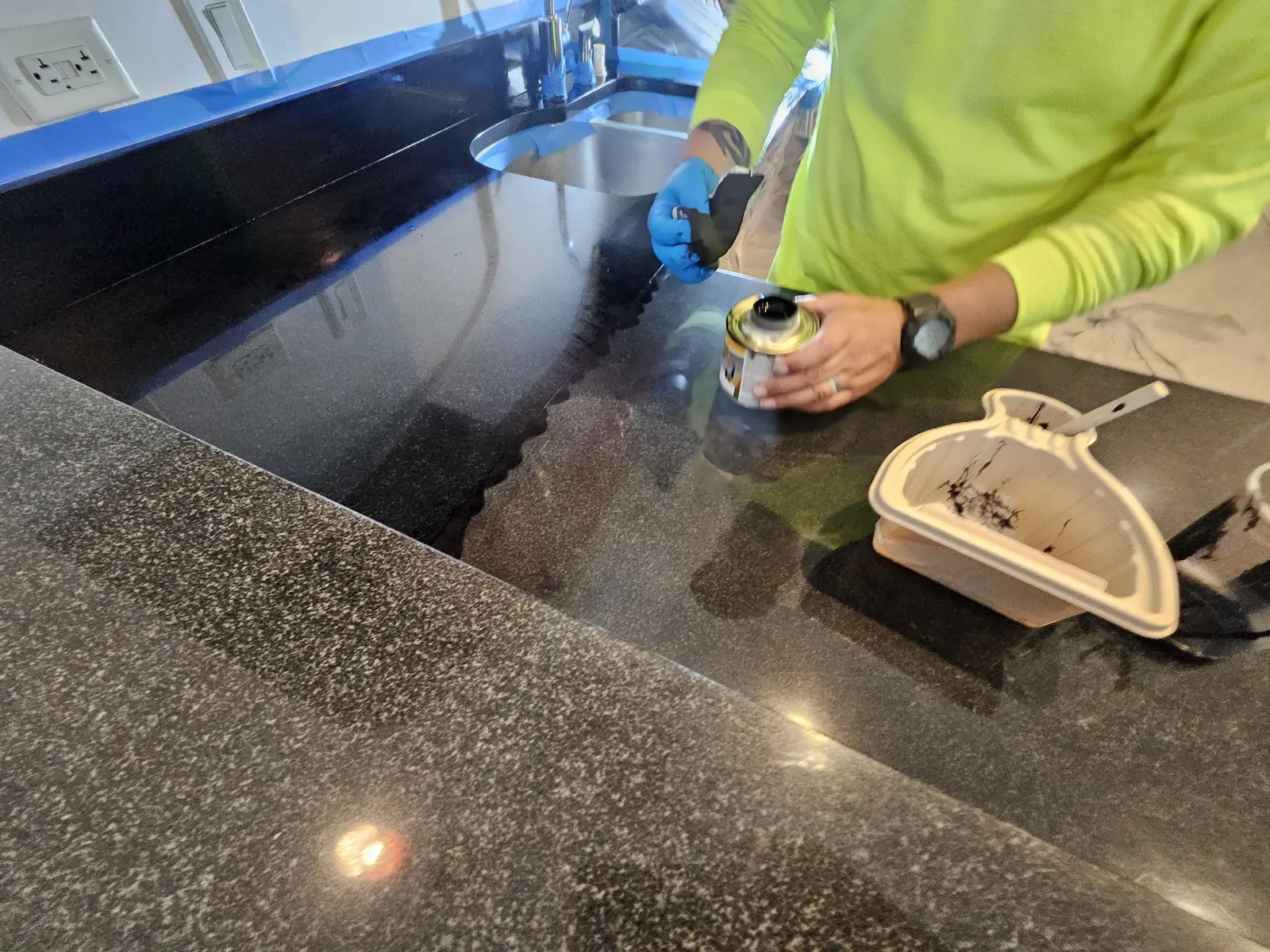 Black granite kitchen counter cleaned and restored near Panorama Towers