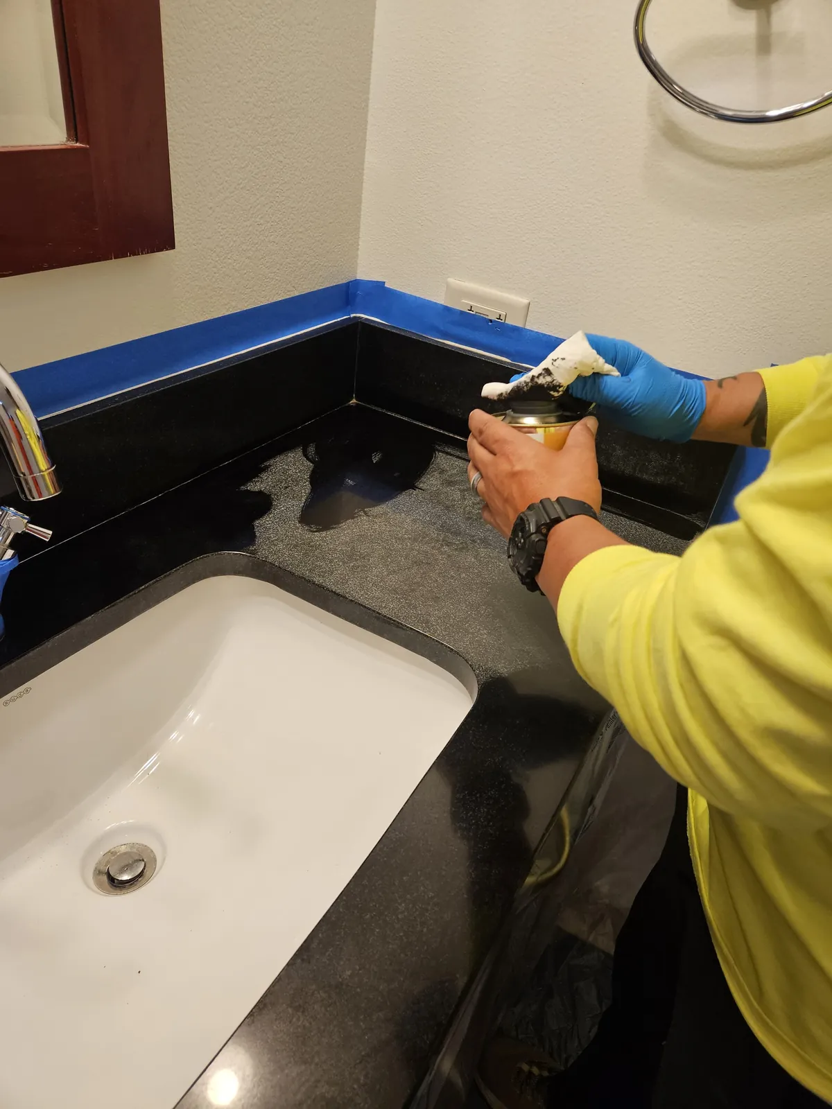 Black granite vanity being sealed near Panorama Towers