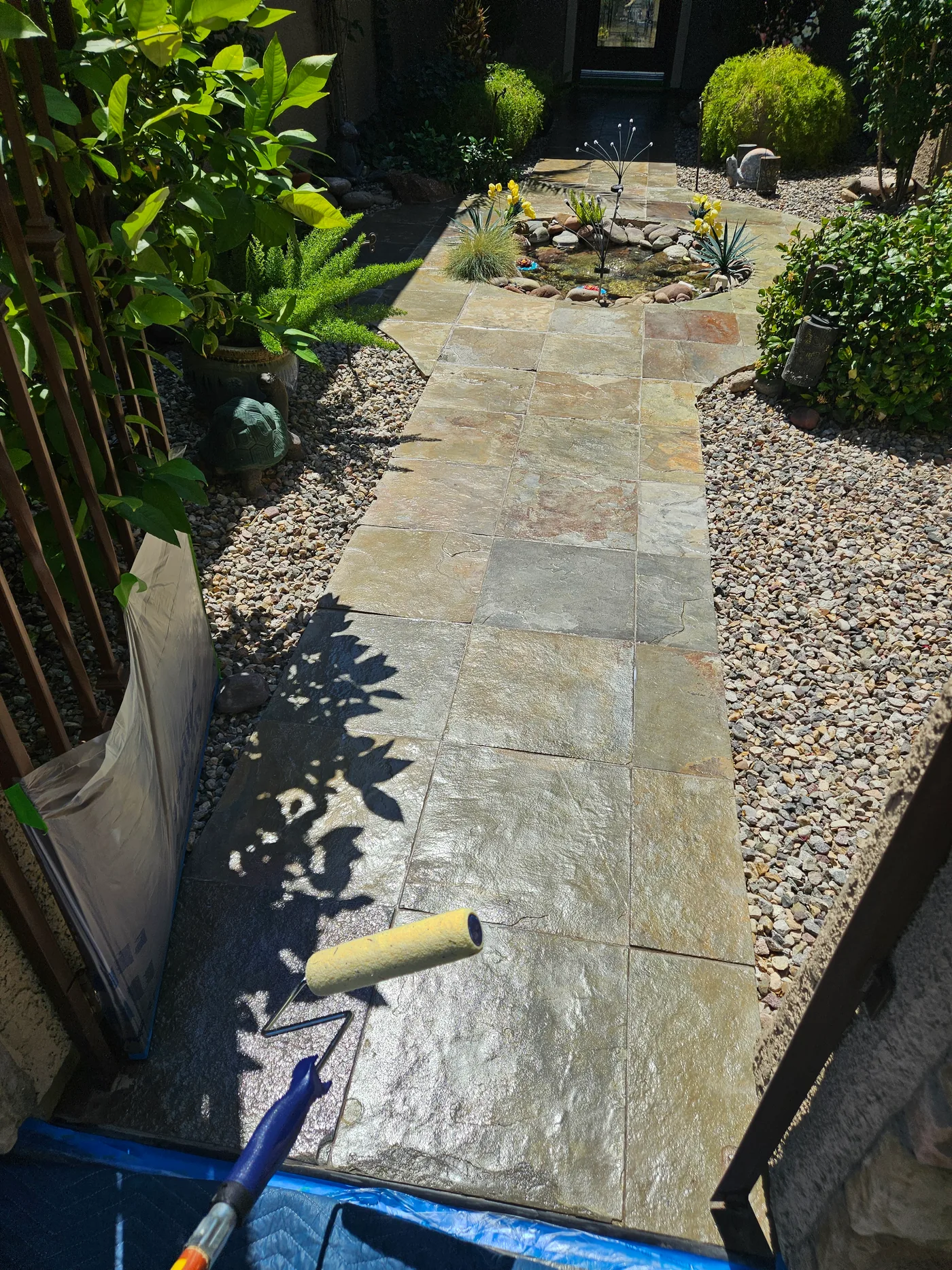 Applying sealer to stone pavers with roller