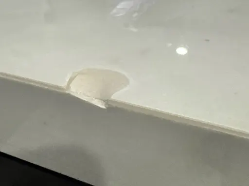 Customer photo of a chipped countertop edge sent by text for a quote