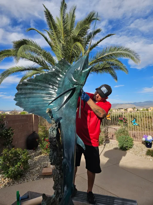 Technician restoring a large outdoor statue