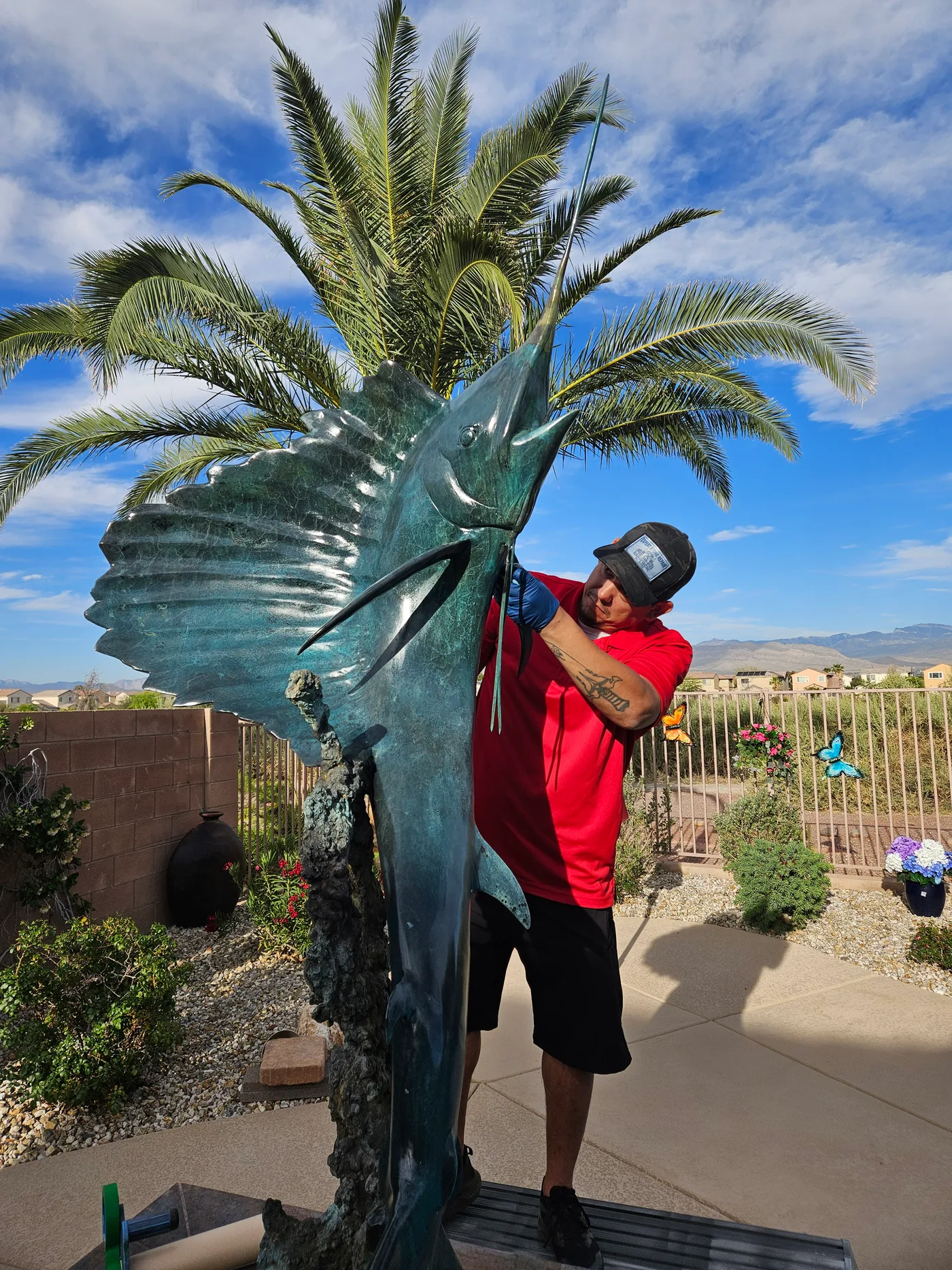 Technician restoring a large outdoor statue