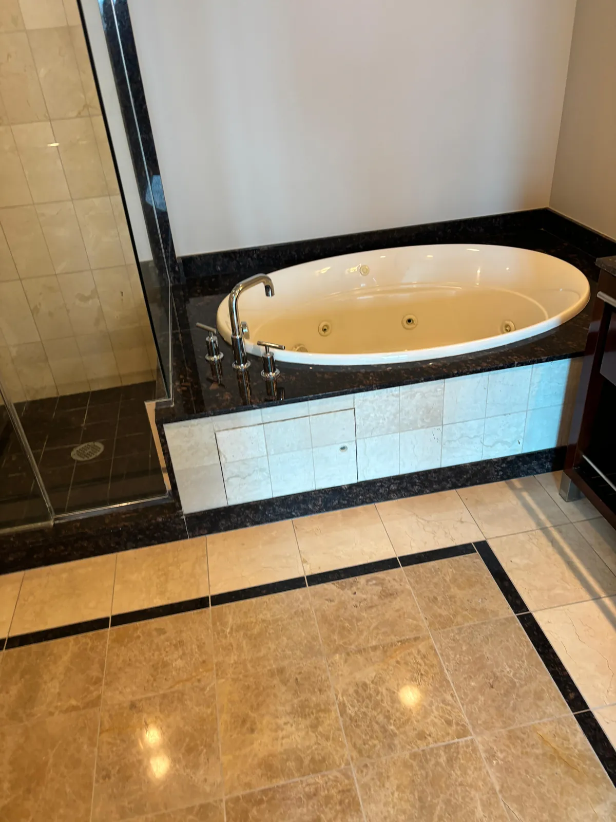 Polished granite tub deck and marble tile floor near Sky Las Vegas