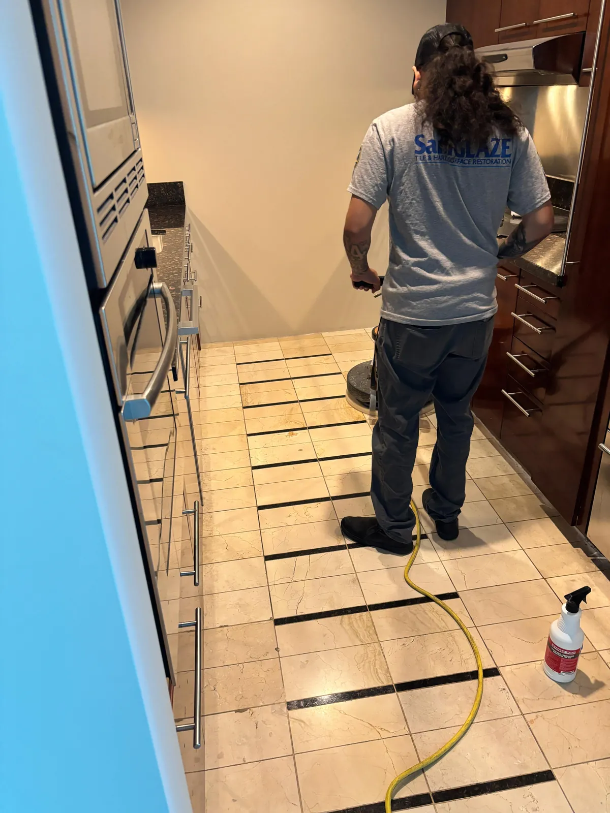 Technician deep-cleaning a marble tile floor near Sky Las Vegas