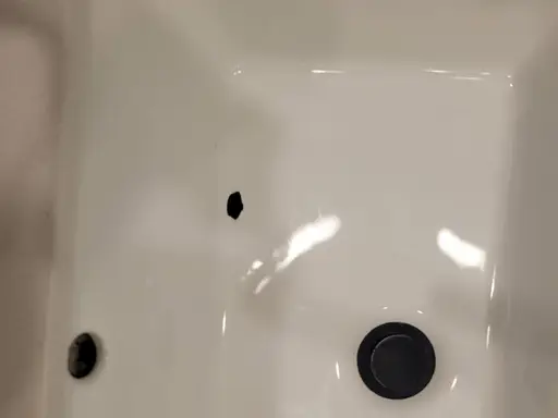 Chip in a white solid-surface sink basin, sent by a customer