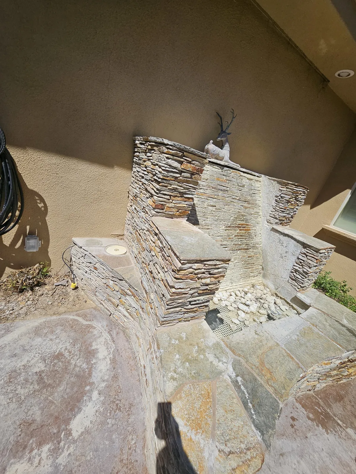 Stacked stone water feature and basin during restoration
