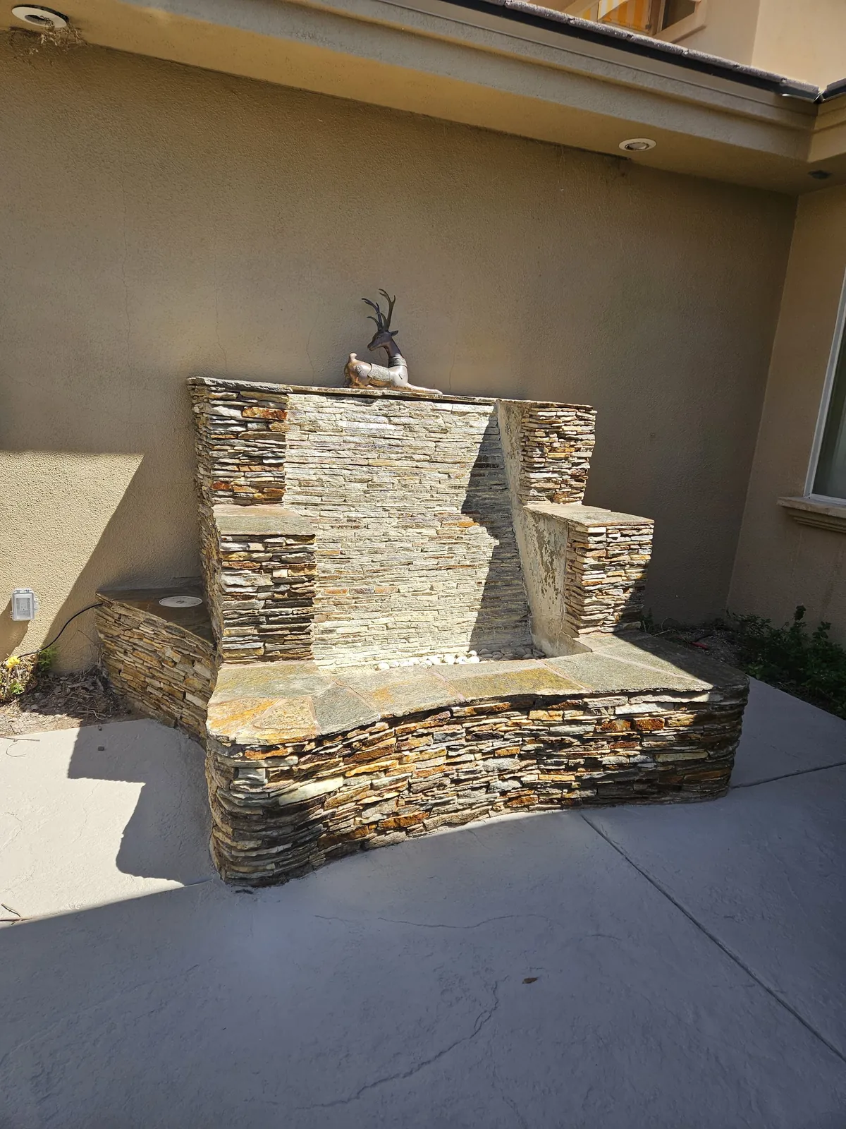 Stacked stone water feature after cleaning, repair, and sealing in Las Vegas