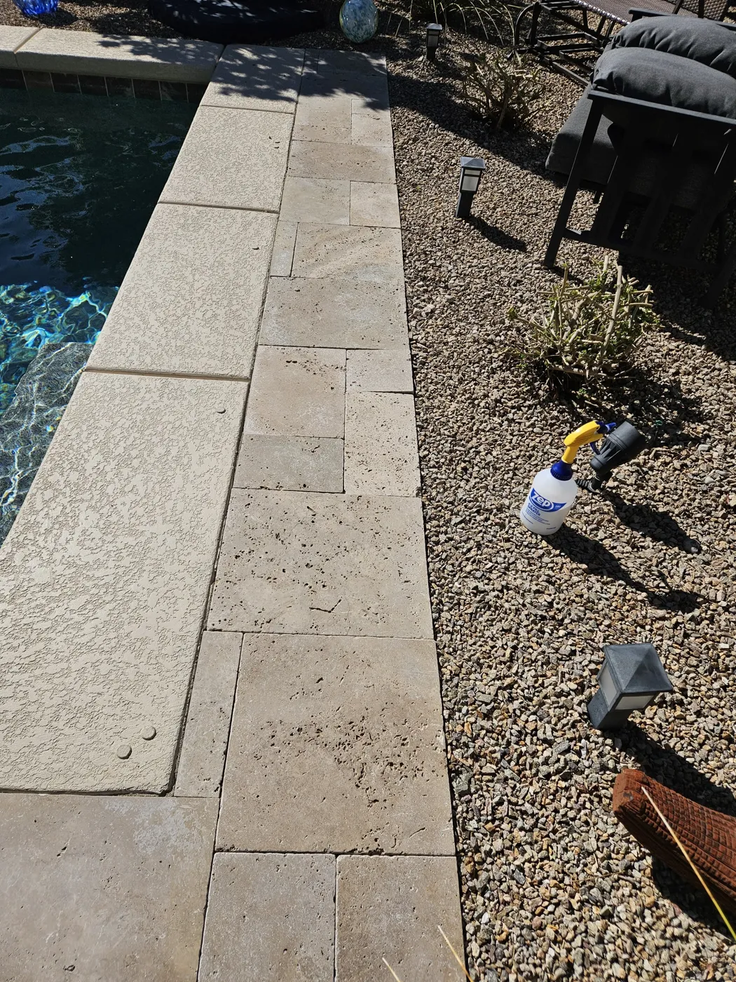 Calcium scale buildup on travertine pool coping before cleaning in Las Vegas