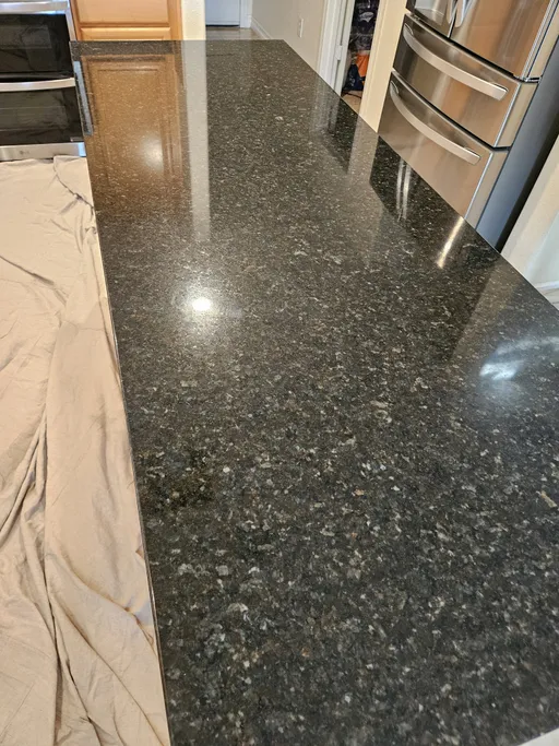 Dark granite countertop — flawless mirror finish