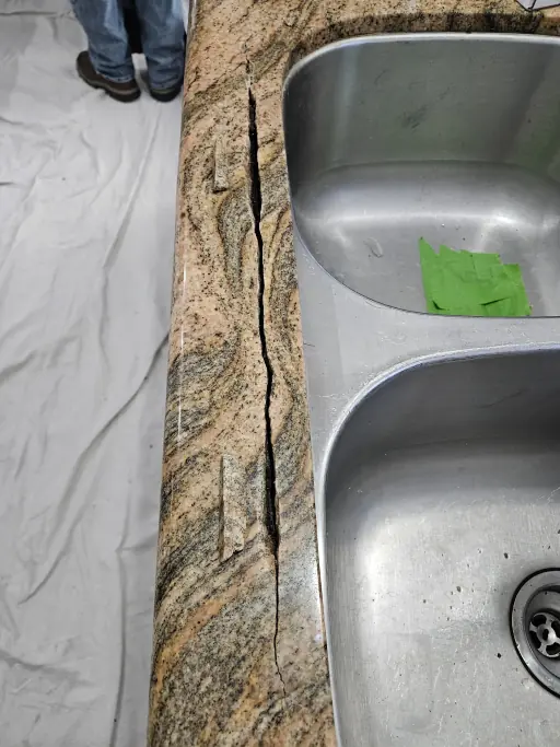 Cracked granite countertop before repair in Henderson