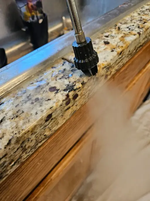 Rotary tool grinding granite edge