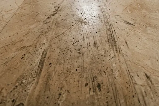 Scratched and worn marble floor showing traffic lane damage