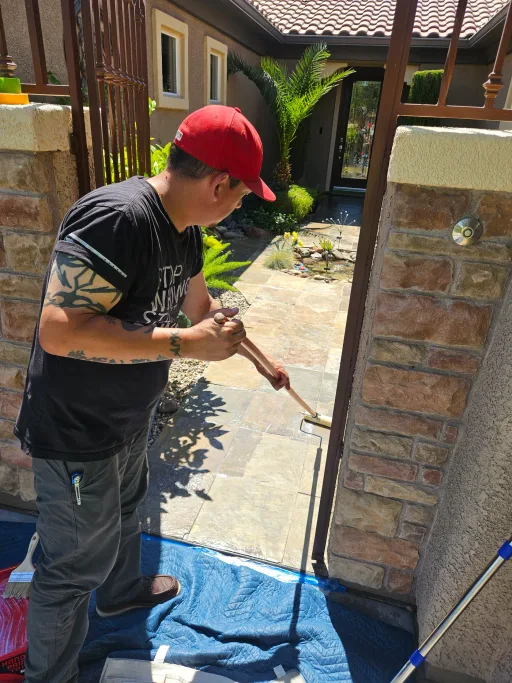 Technician actively restoring pavers during cleaning and sealing work