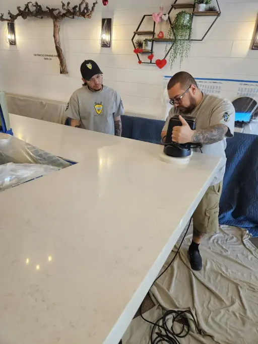 Two technicians polishing quartz bar