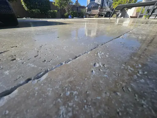 Sealed travertine surface with water beading in Henderson